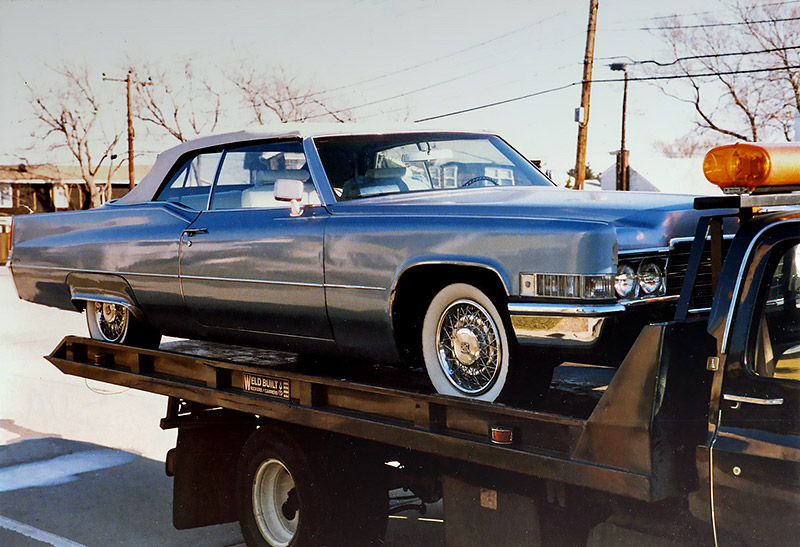1969 Caddy on Flatbed front at Carefully-carried Cadillac convertible cargo at Lido Beach Boulevard., Lido Beach, Long Island, NY